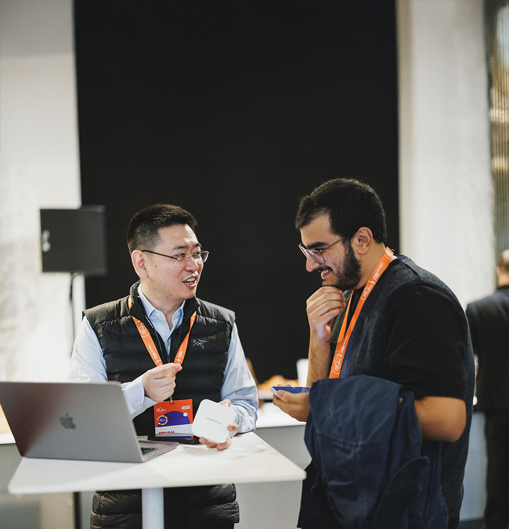 Two men talking at an open innovation event