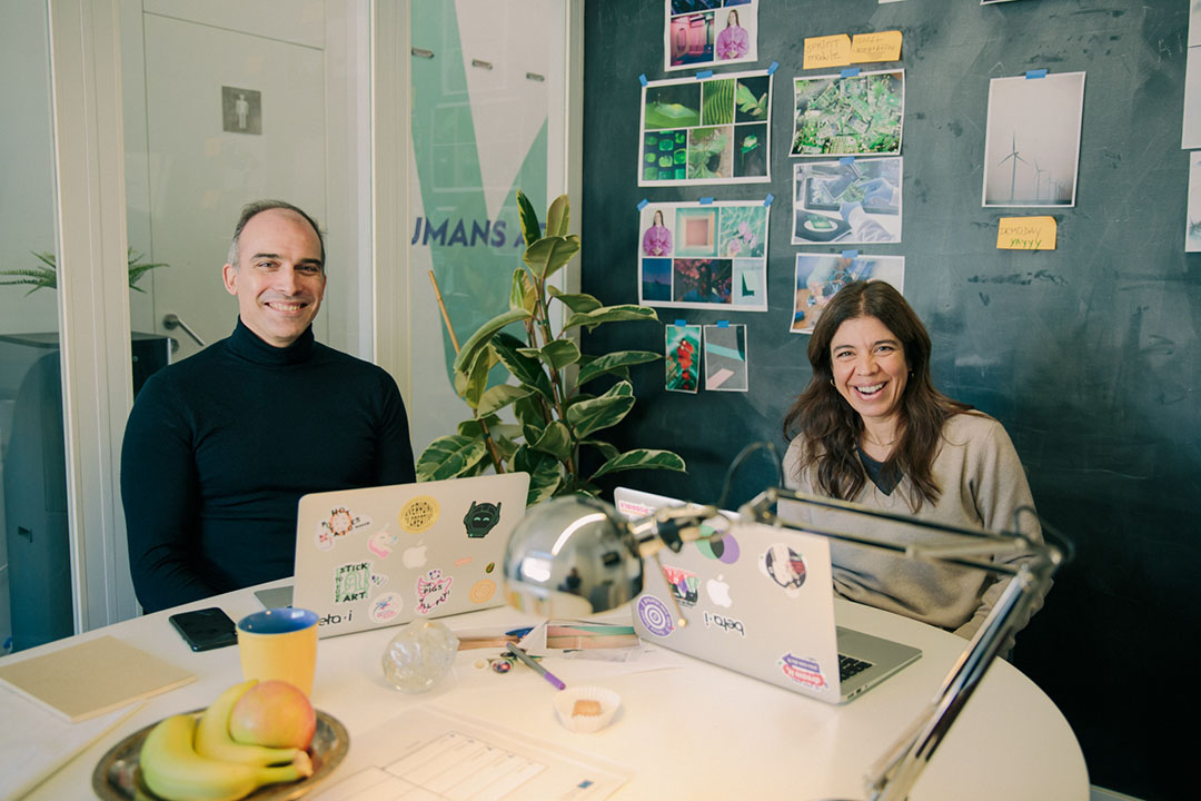 A man and a woman smiling at the office